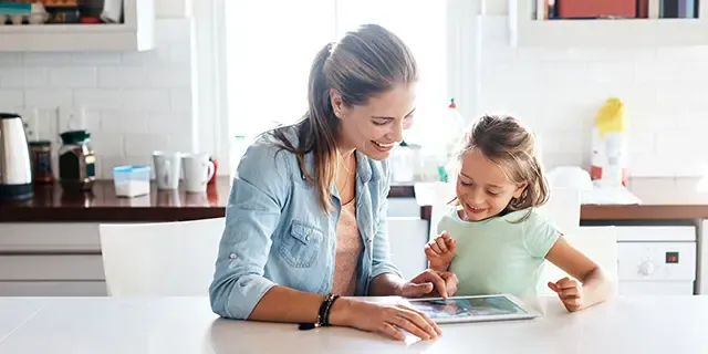 Mom and daughter using ipad